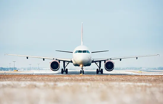 A passenger jet on the runway, facing the camera